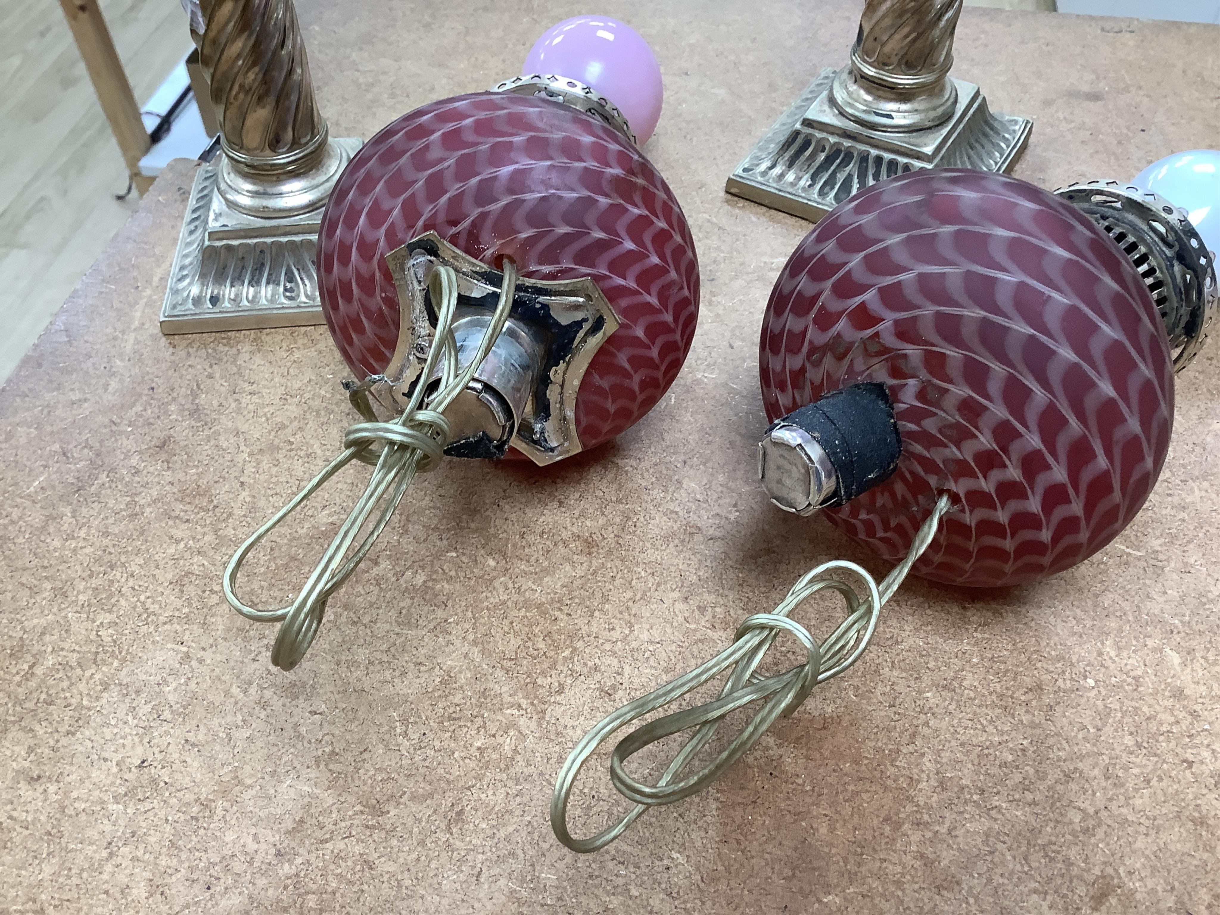 A pair of electroplate and ruby glass oil lamps, 35cm. Condition - good, not tested as working